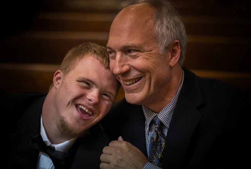 older father and son dressed in suits smiling, smiling together 4k