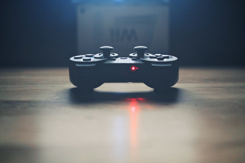 a sony playstation remote control and a wii box, playstation game controller 4k