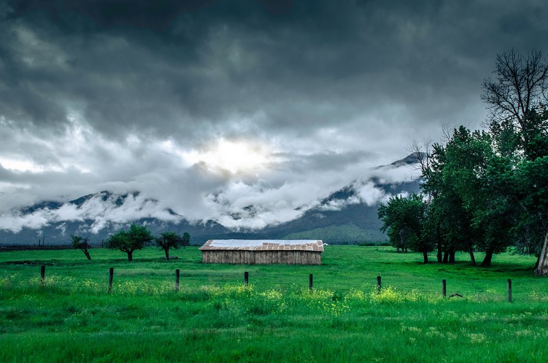 cloudy skies over a lush green pasture with an abandoned barn, greener pastures 4k
