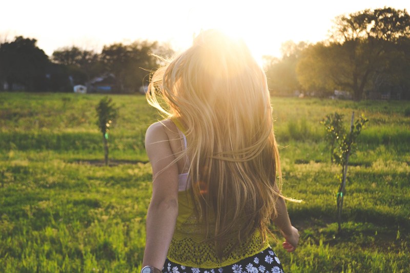 an absolute beautiful sight of a young blonde girl bathed in sunlight, sunlight welcomes blonde girl 4k
