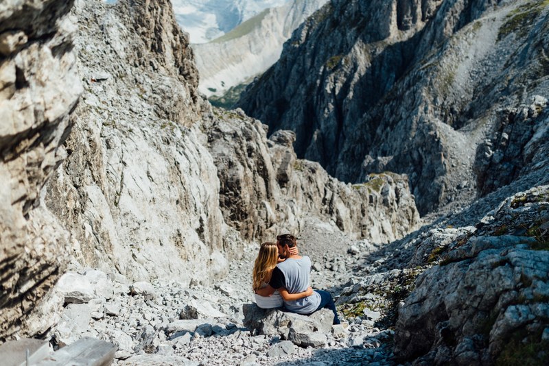 couple embraces in a rocky mountain landscape, couple in the alps 4k