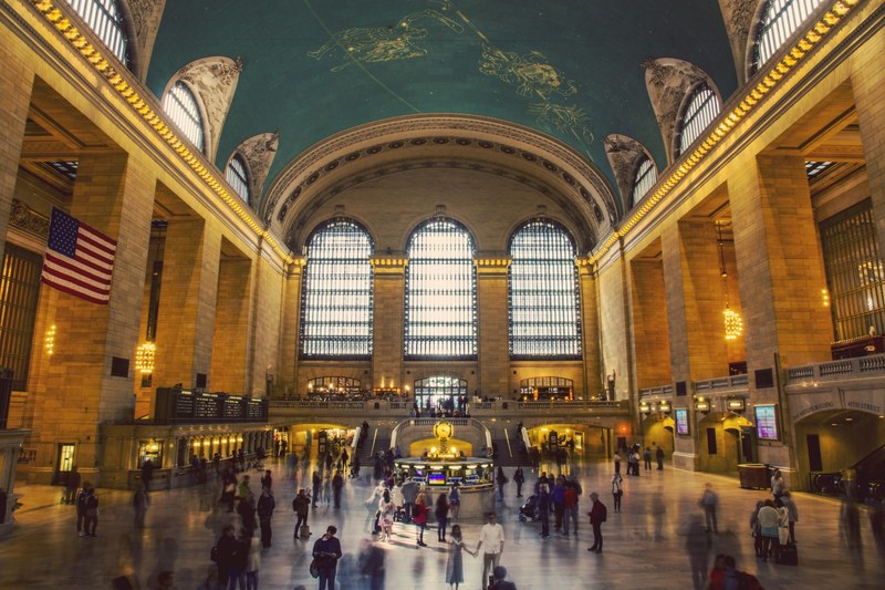 the interior of new yorks grand central station with an american flag on one of the walls, golden grand central station 4k