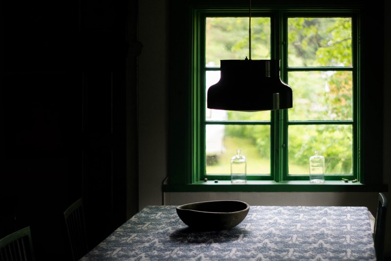 window with green frame from dark interior with table decor hanging light and bowl borlnge, borlnge green frame window 4k