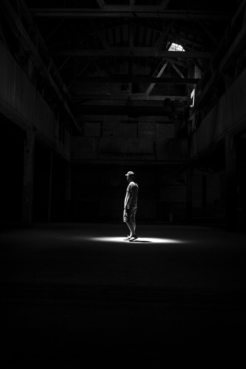 a dark black and white photo of a man standing in a building in red hook brooklyn new york, red hook black and white 4k