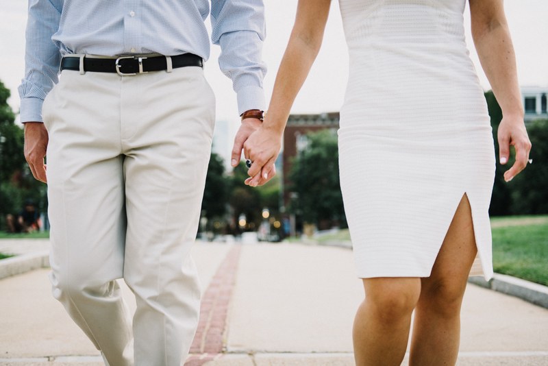 a dressed up couple holds hands and strolls on a path through a boston park, strolling through boston 4k