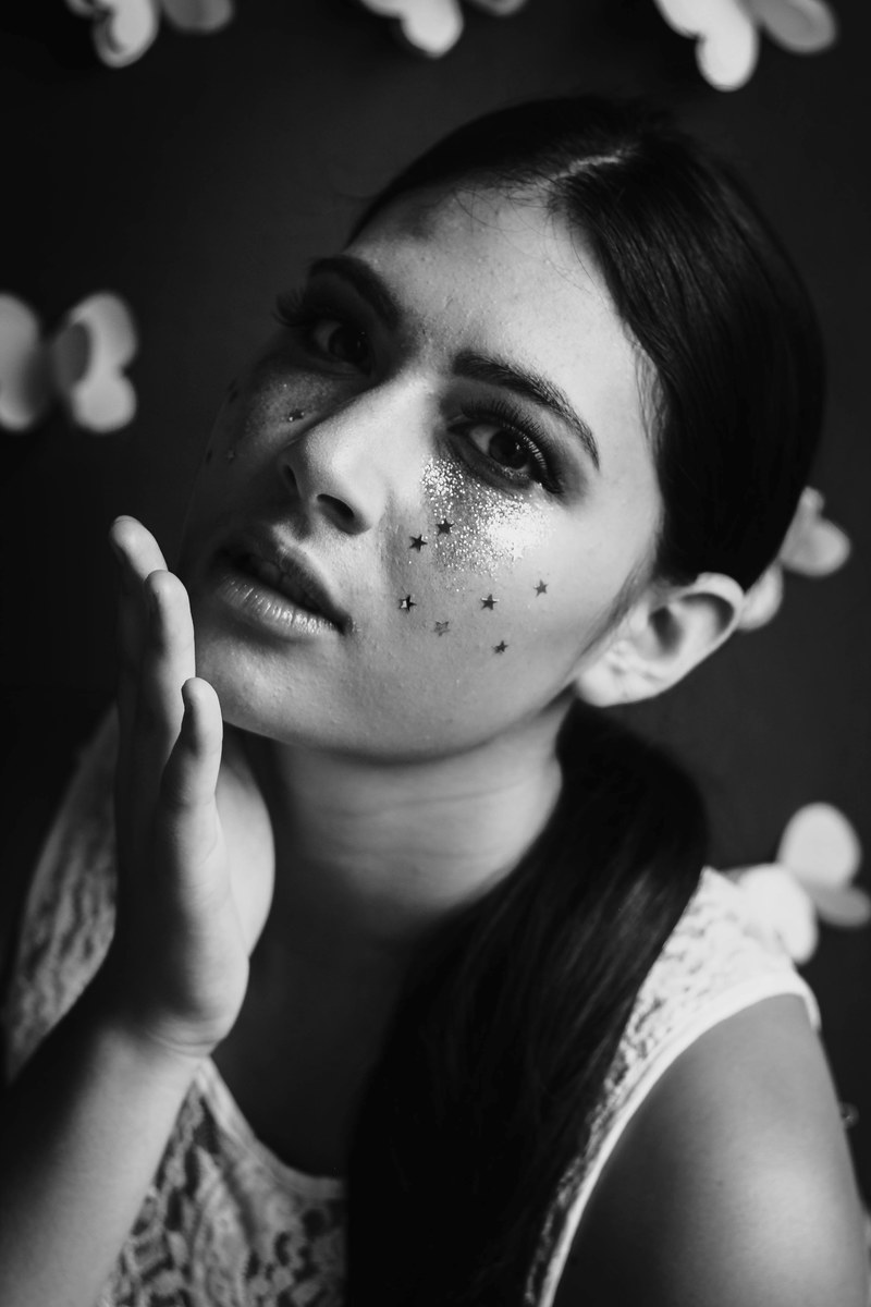 black and white shot of attractive woman with dark hair and face glitter, monochrome woman face glitter 4k