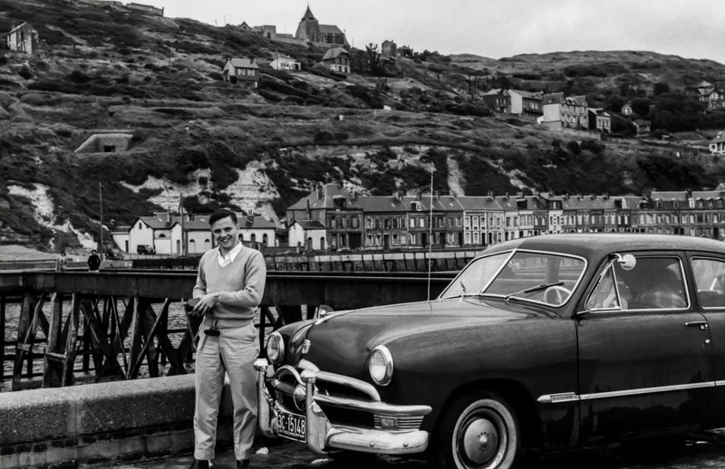 black and white shot of man in jumper with vintage classic car in village, man village and vintage car 4k
