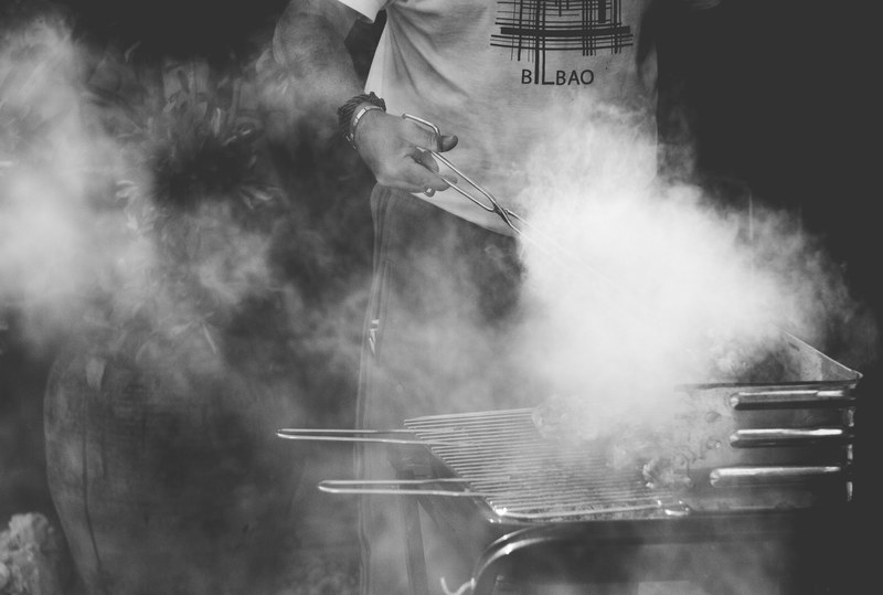 a person cooking food over a smokey barbeque in vinars, great sunday 4k