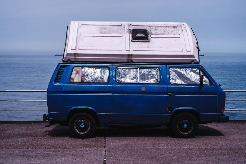 blue van with window protectors and a container on the roof, camper numero uno 4k