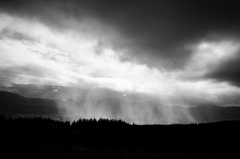 a black and white photo of heavy rain clouds over a lake, lake under heavy rain 4k