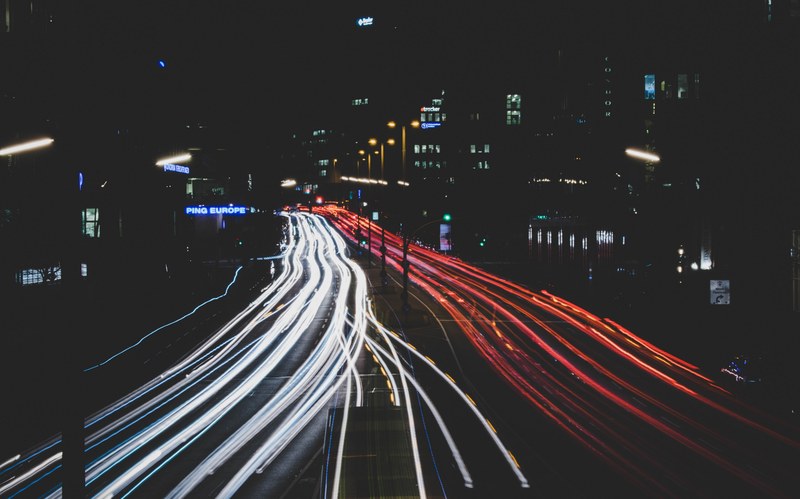 red and white car light trails on an urban highway at night in rddingsmarkt, light car traffic and night 4k