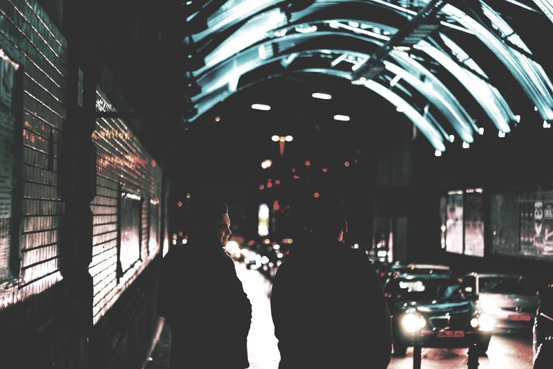 tunnel in the city at night near traffic with silhouettes of people, night city tunnel 4k
