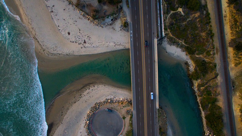 drone shot of highway bridge in cardiff suspended above water and sand, drone shot cardiff bridge 4k