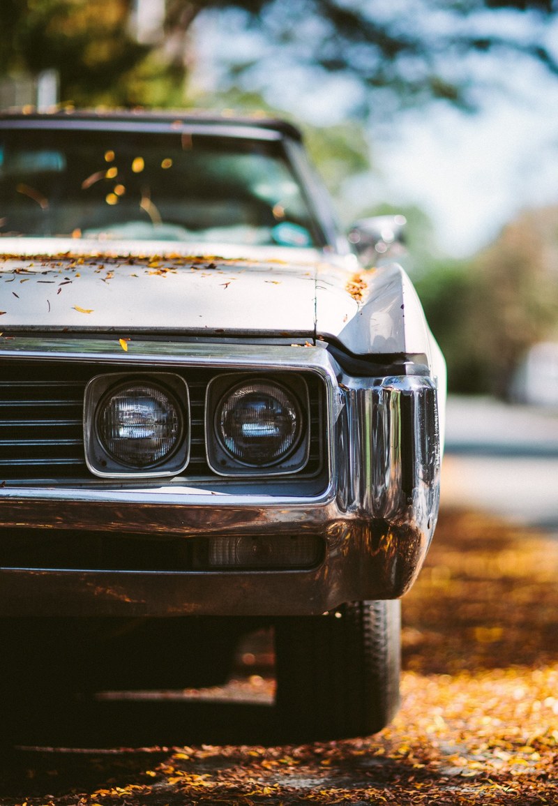 a vintage car with square headlights parked on a street covered in leaves in strathcona, strathcona vintage car 4k