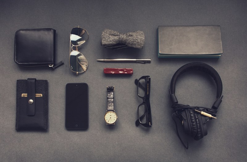 a flatlay with sunglasses a watch a bowtie and other personal belongings, accessories on gray 4k