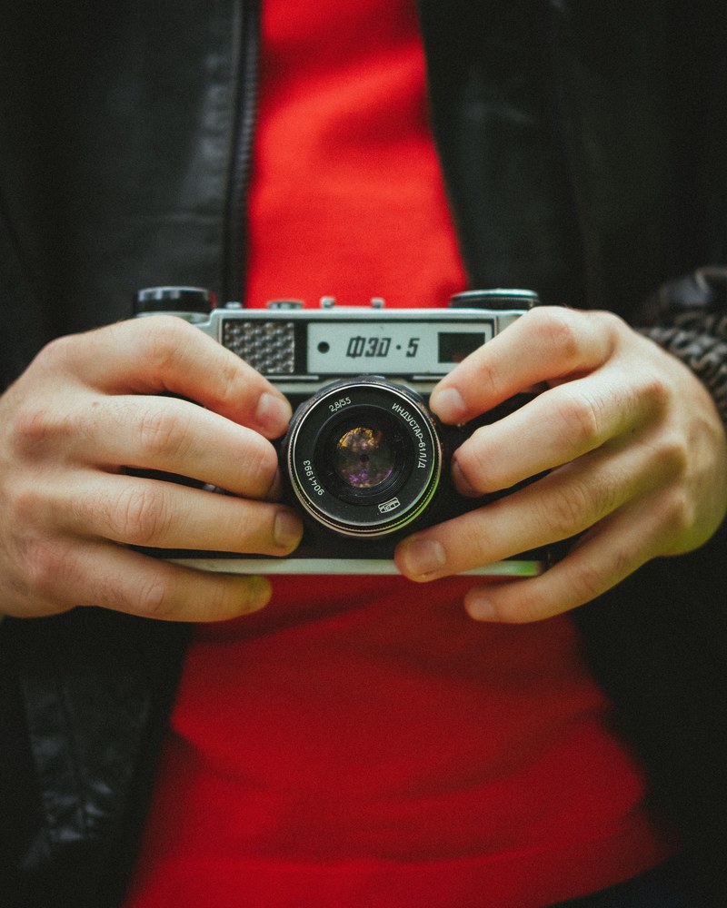 a man holding a camera in his hands, _man holding camera 4k