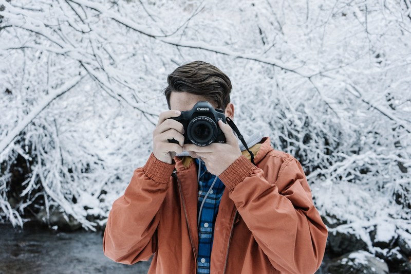 a man holding a dslr camera taking a picture of the fourth wall, picture of picture taker 4k