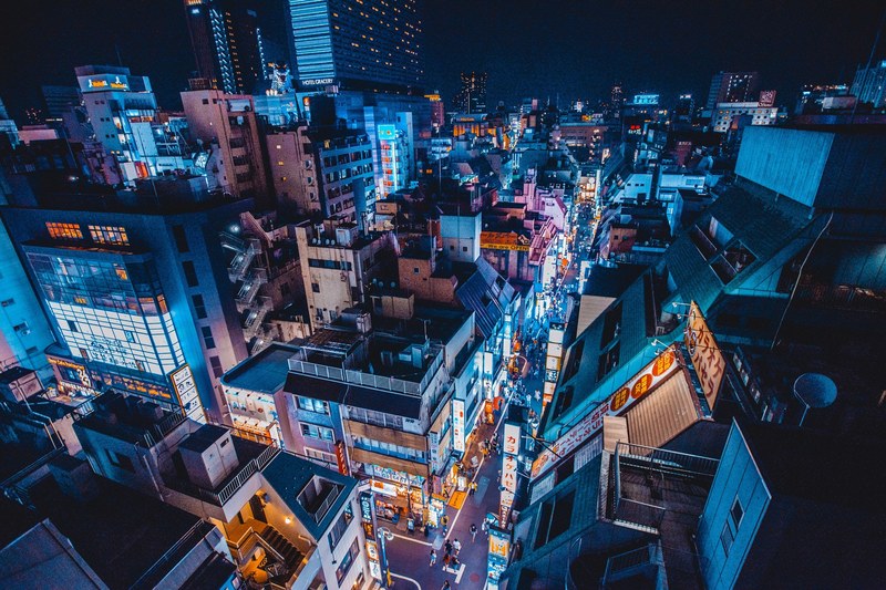 a high shot of a neon soaked street in tokyos shinjuku district, shinjuku in blue 4k