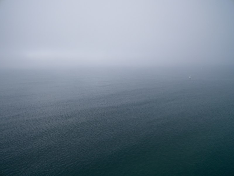 drone aerial view of the ocean on a foggy day at redondo beach, swallowed in the sea 4k