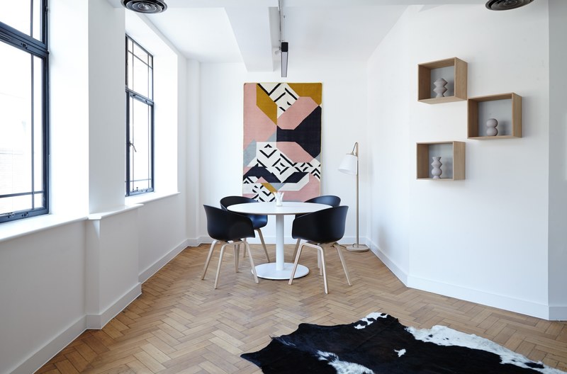 a minimal creative room with a round white table and sparse decorations, minimal creative interior 4k