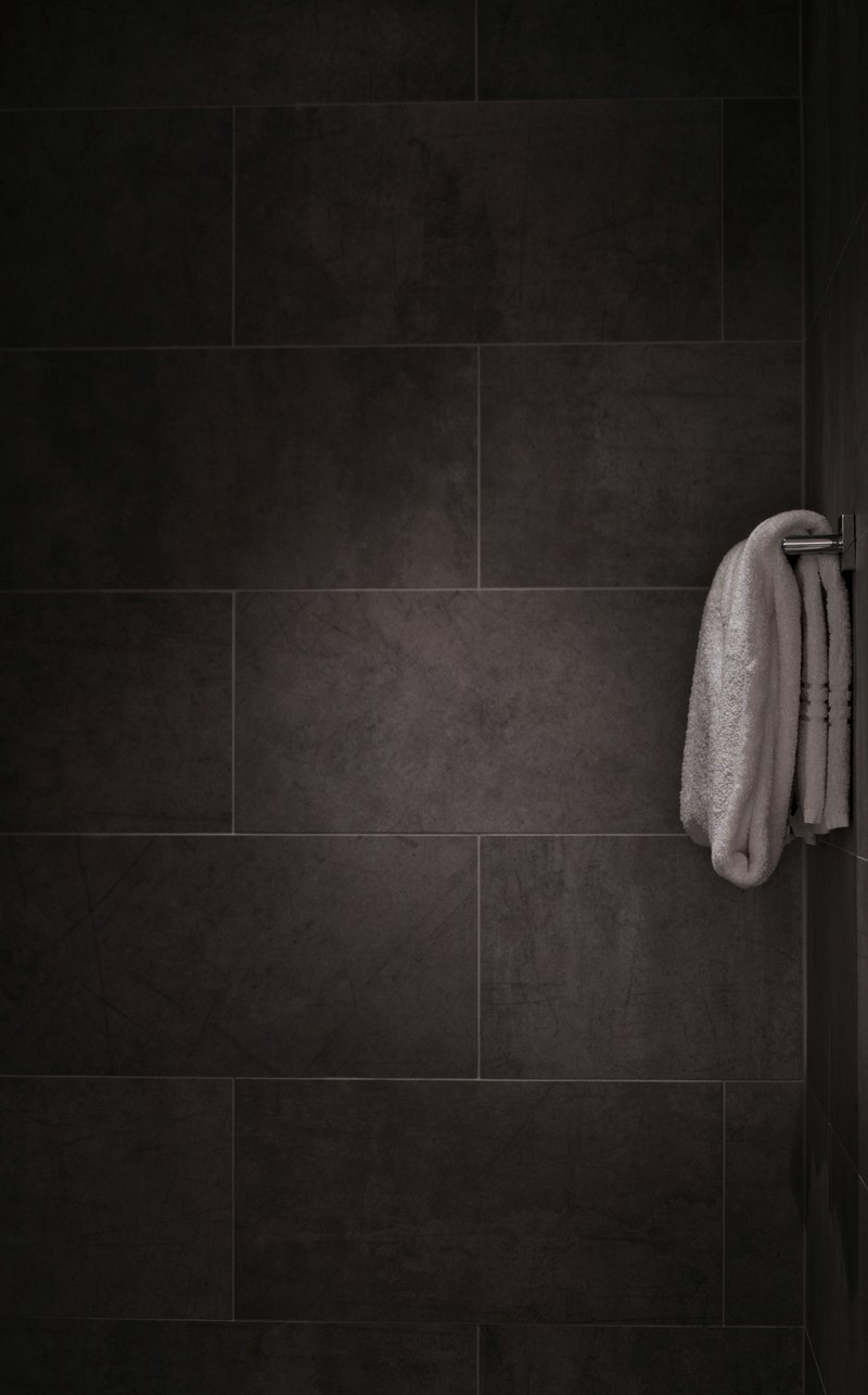 black and white minimalist shot of white towel on rail in tiled bathroom, white towel in tiled bathroom 4k