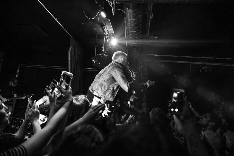 a man singing to a crowd of people taking photos with their cellphones at a concert, concert photos 4k