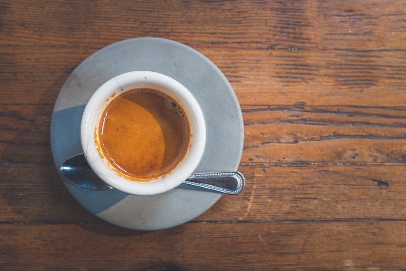 a coffee cup and a spoon on a saucer filled with espresso, espresso 4k