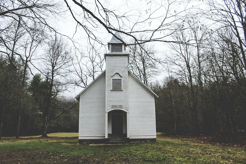 a small wooden chapel near a forest in cataloochee, small white chapel 4k