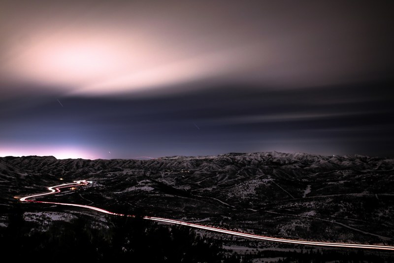 a late evening early night image from a drone displaying a citys skyline and sky, drone view of a night sky 4k