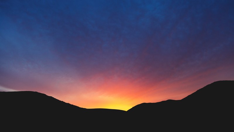 a sunset or sunrise that paints the sky orange yellow pink and purple, purple and pink sky 4k