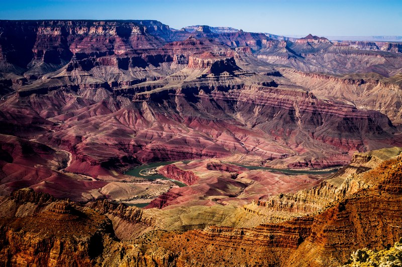 grand canyon aerial shot showing the ravine and layers of red and orange rocks, colorful grand canyon 4k