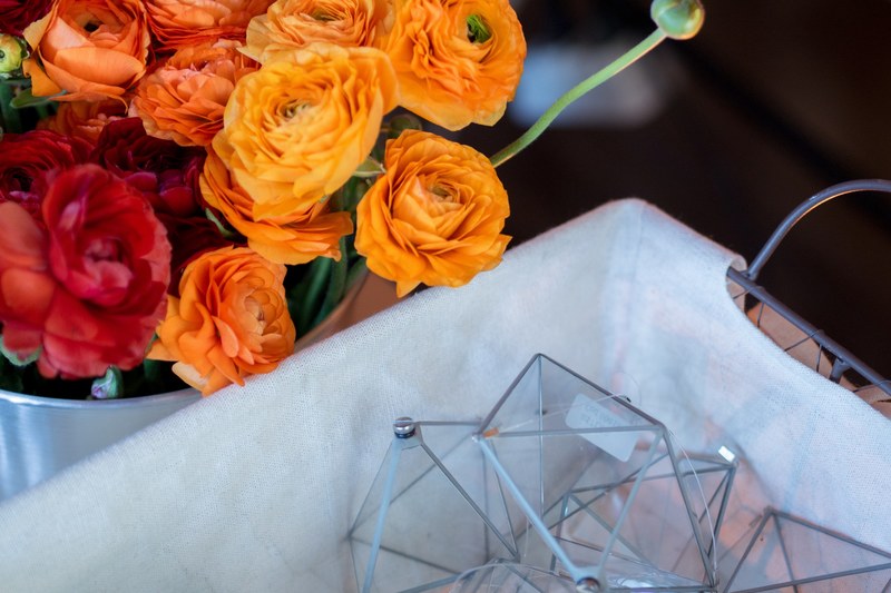 a large bouquet of red and orange roses in a bucket next to a basket with glass prisms, flower bouquet and prisms 4k