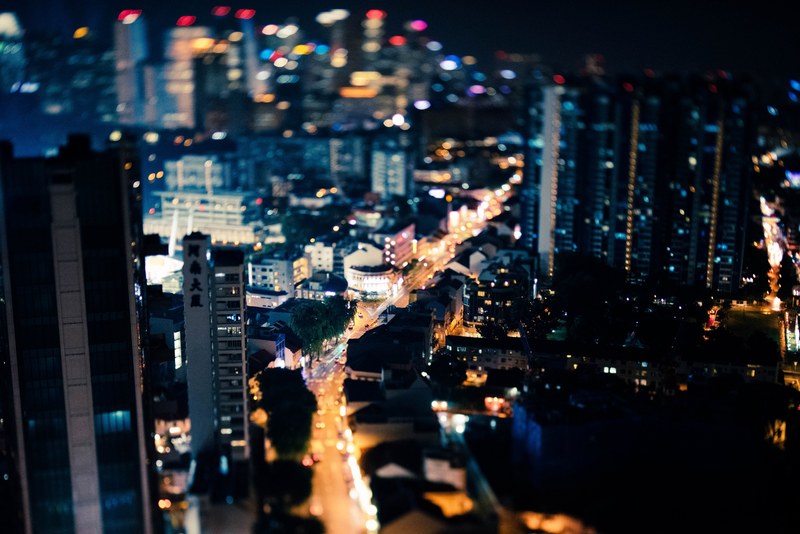 a high shot of a well lit street in the downtown of an asian city, tiny metropolis 4k