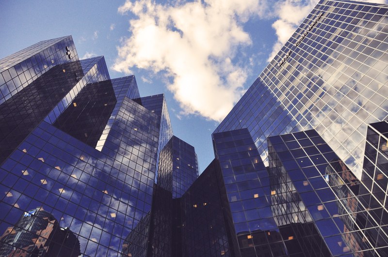low angle shot of several skyscraper towers with reflective glass facades, montreal offices 4k