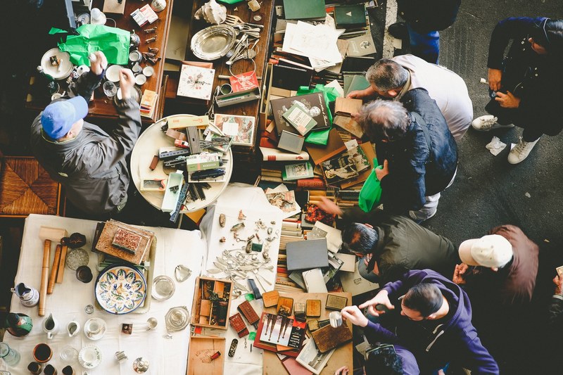 an overhead shot of people browsing books and trinkets at a flea market, flea market from above 4k