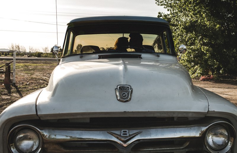 a couple kissing inside an old vintage ford truck on a farm, couple kissing inside an old truck 4k
