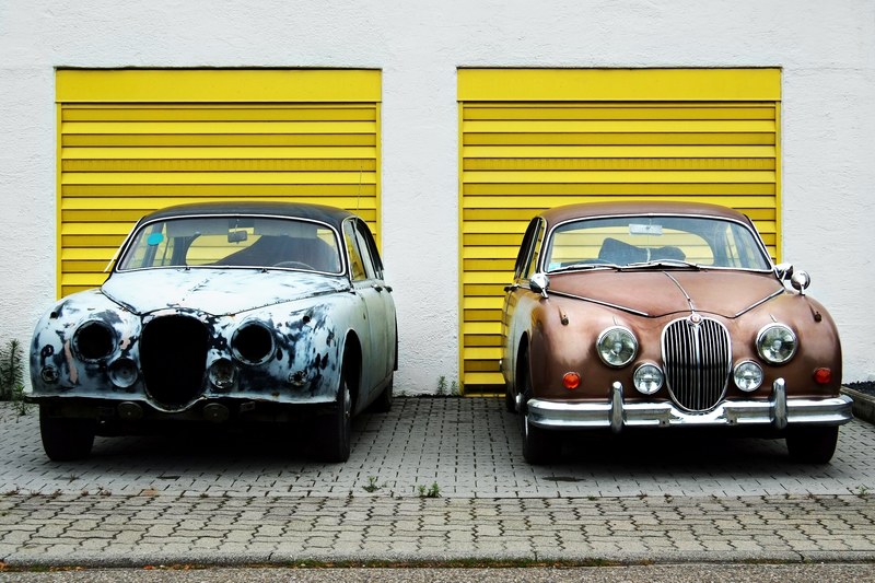 damaged and repaired antique retro classic cars parked in front of yellow garages, retro cars in front of yellow garage 4k
