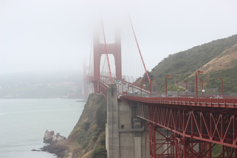 long shot of misty golden gate bridge in san francisco with busy daytime traffic, golden gate bridge on misty day with traffic 4k