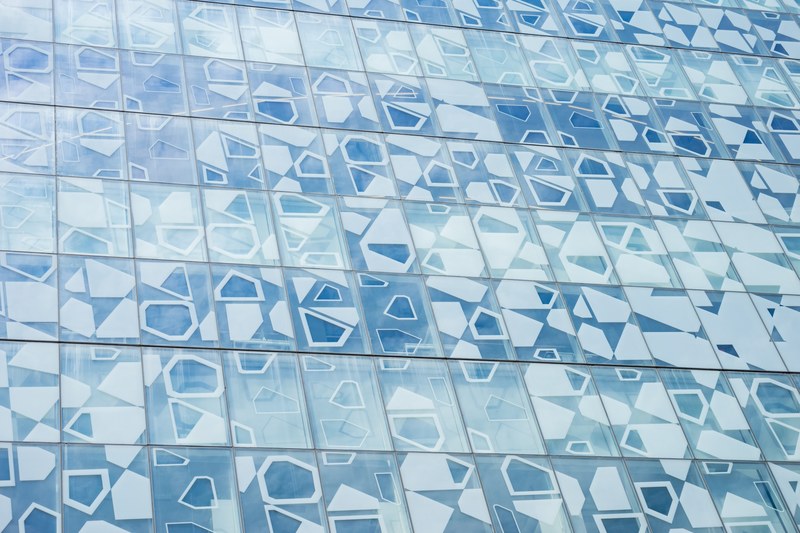 a blue facade with geometric shapes painted on the windows, looking closer 4k