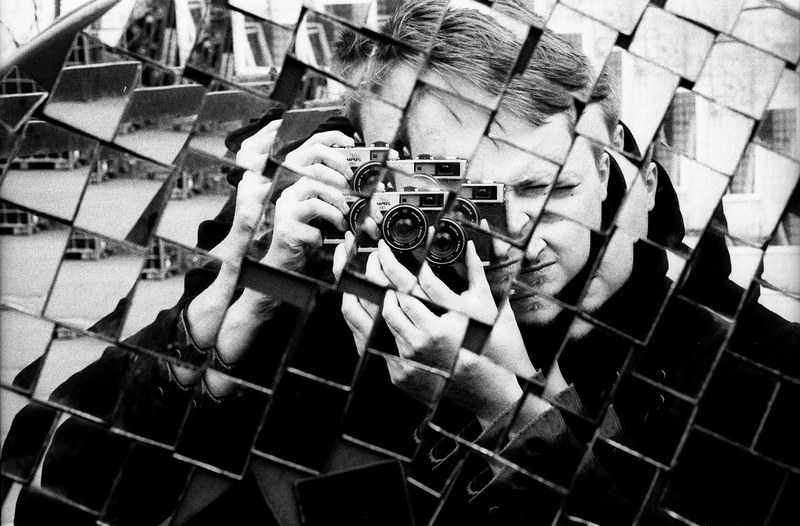 black and white shot of mans reflection holding camera taking photo in textured mirror teufelsberg, textured mirror photo 4k