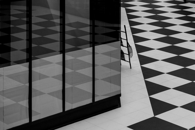 black and white shot of monochrome square floor pattern and tall window with reflection, monochrome floor pattern 4k