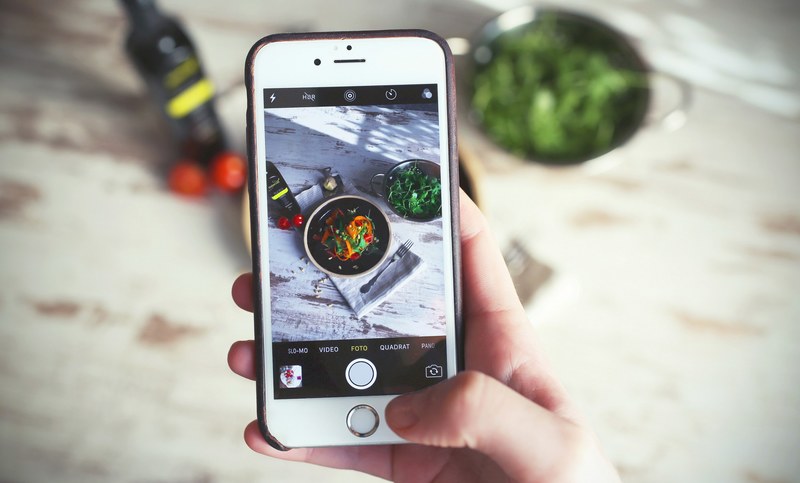person taking an instagram photo on an iphone of their food, sugerfree 4k