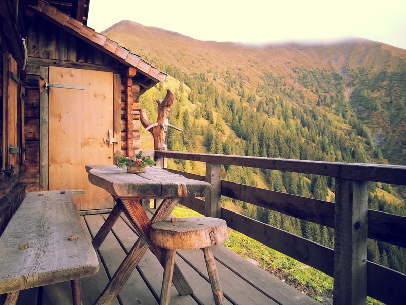 table and chair on a cabin balcony overlooking the lush forest, _cabin balcony in forest 4k