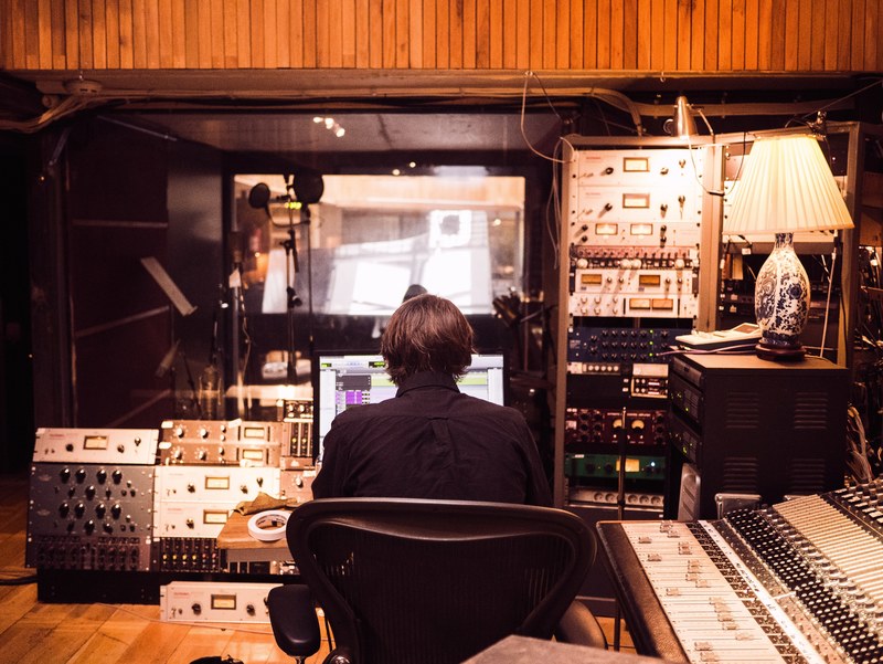 a man working on a computer in a recording studio, mixing session 4k