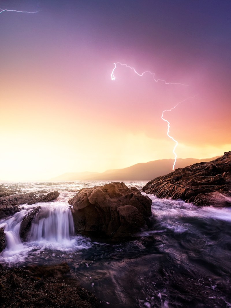 rocky lagoon with lightning strike in the background at laguna beach california united states, ocean lighting strike 4k