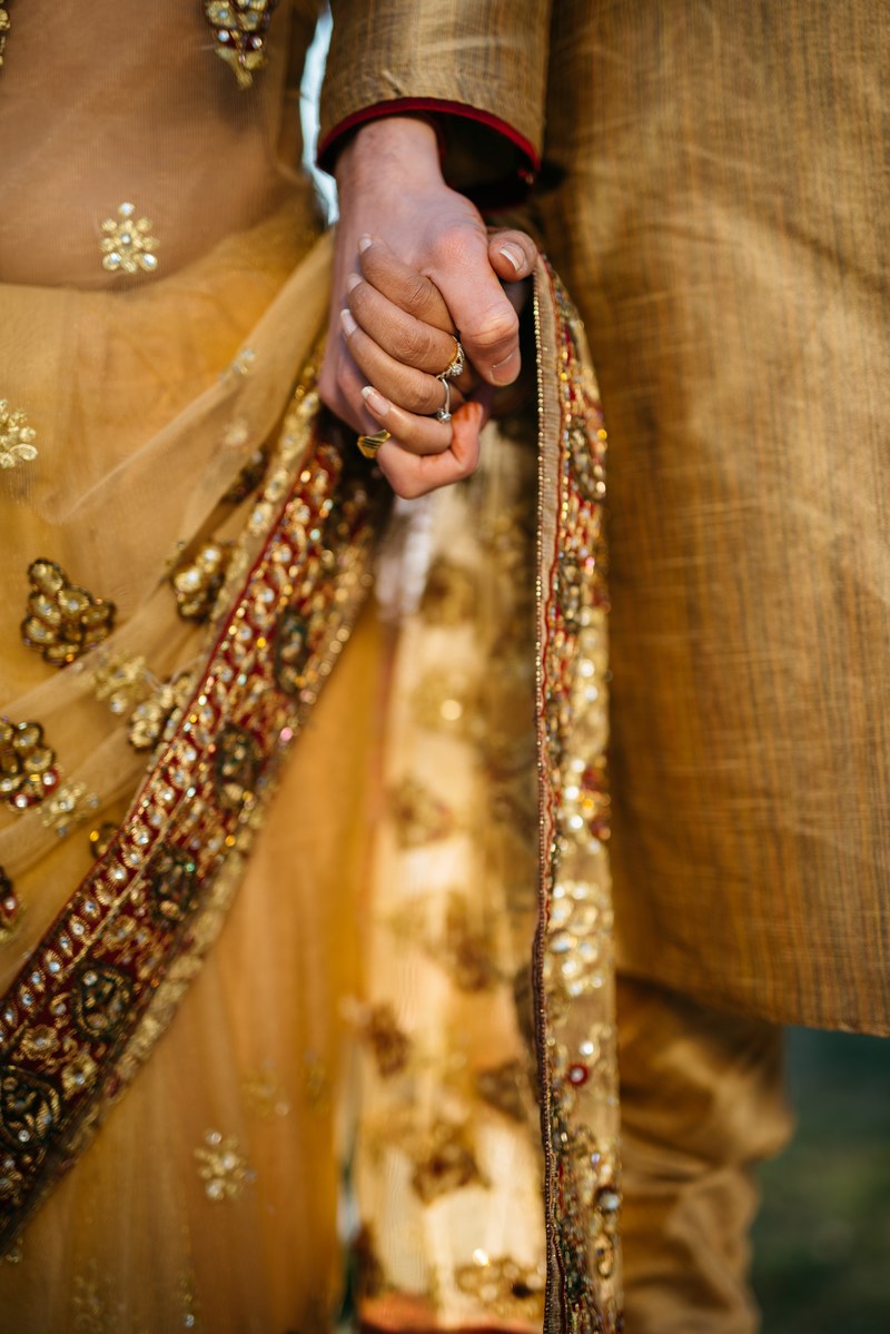 couple in traditional garb holds hands at wedding, indian wedding couple 4k