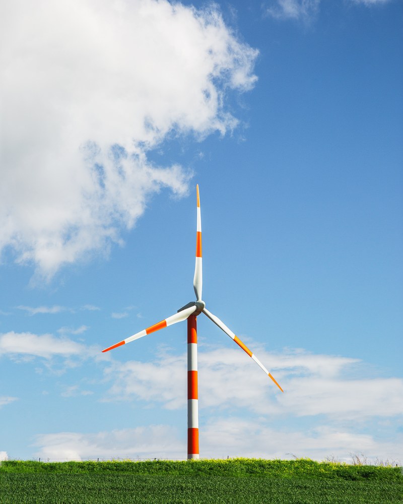 a lone red and white wind turbine against the bright cloudy sky in kfar kama, _windmill 4k