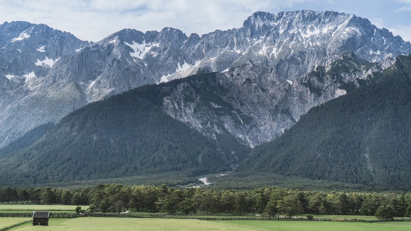a steep mountain face with wooded slopes, steep mountainside 4k