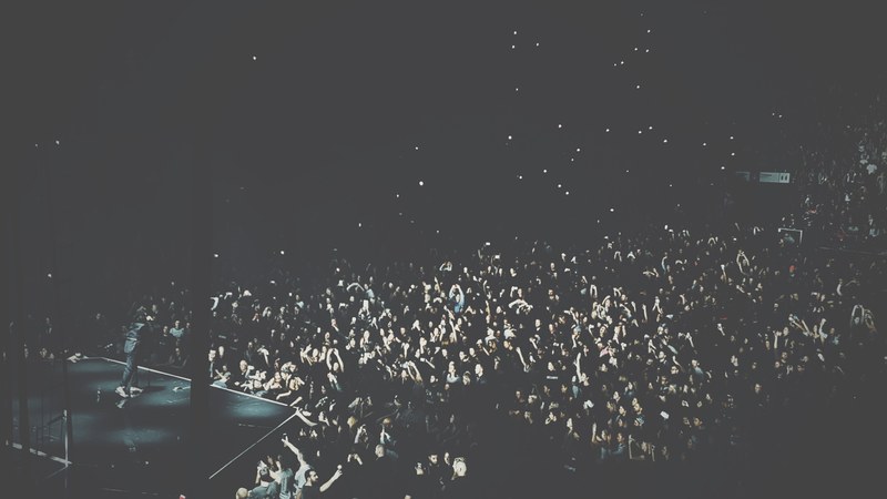 a high shot of a large crowd of people filling up a venue during a concert, sold out concert in montreal 4k