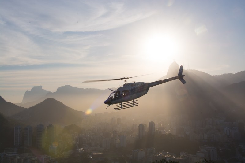 the silhouette of a helicopter flying over rio de janeiro, _helicopter silhouette 4k